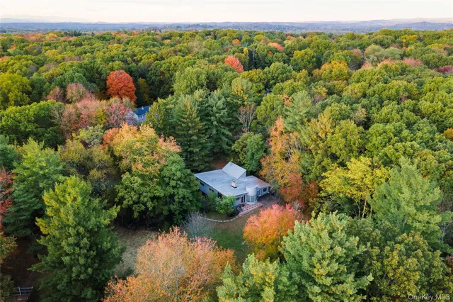 a view of a livingroom with lounge chair and a large window