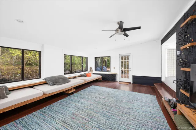 a dining room filled with furniture and a flat screen tv
