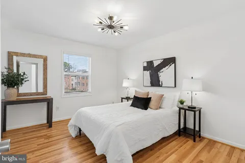 a bedroom with a bed and a potted plant