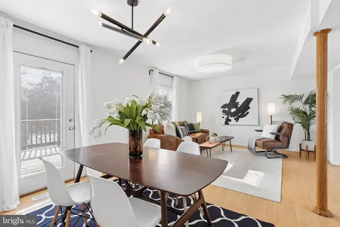 a view of a dining room with furniture and a potted plant