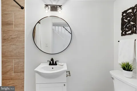 a bathroom with a sink a shower and a mirror