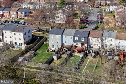 a view of a house with wooden stairs and a small yard