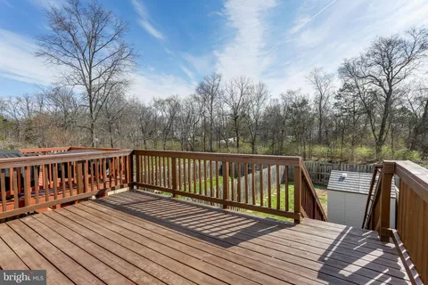 a view of balcony with wooden floor and fence