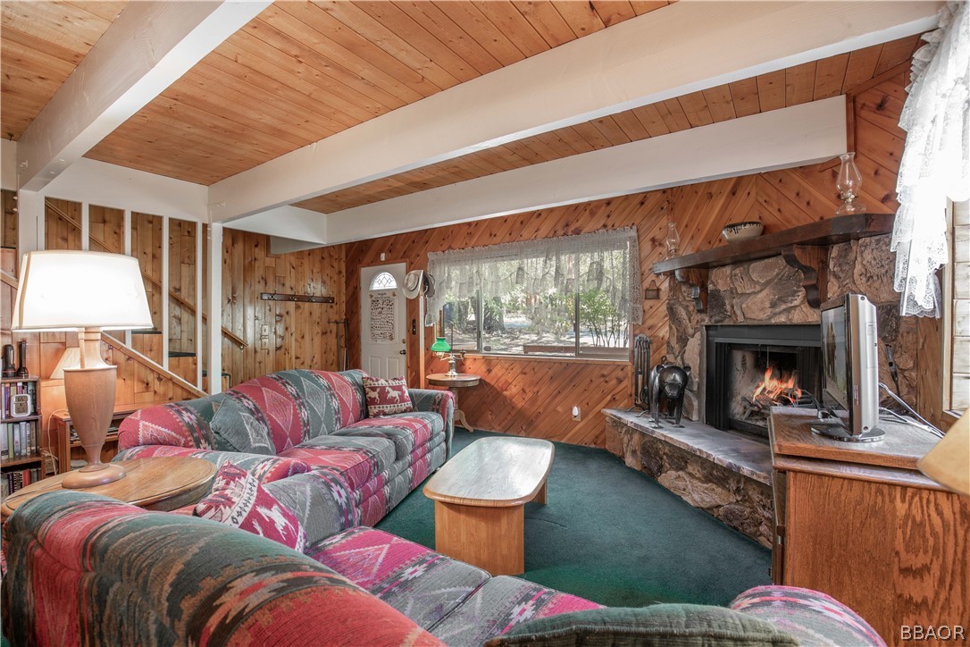 753 Maple Lane Sugarloaf, CA 92386 - Photo 14 of 42 a living room with furniture large window and a fireplace