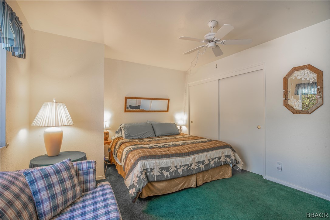 753 Maple Lane Sugarloaf, CA 92386 - Photo 22 of 42 a bedroom with a bed mirror and a window