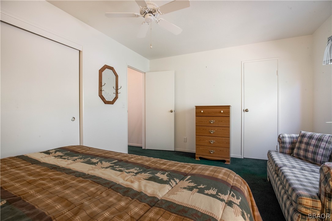 753 Maple Lane Sugarloaf, CA 92386 - Photo 24 of 42 a bedroom with a bed and a chandelier
