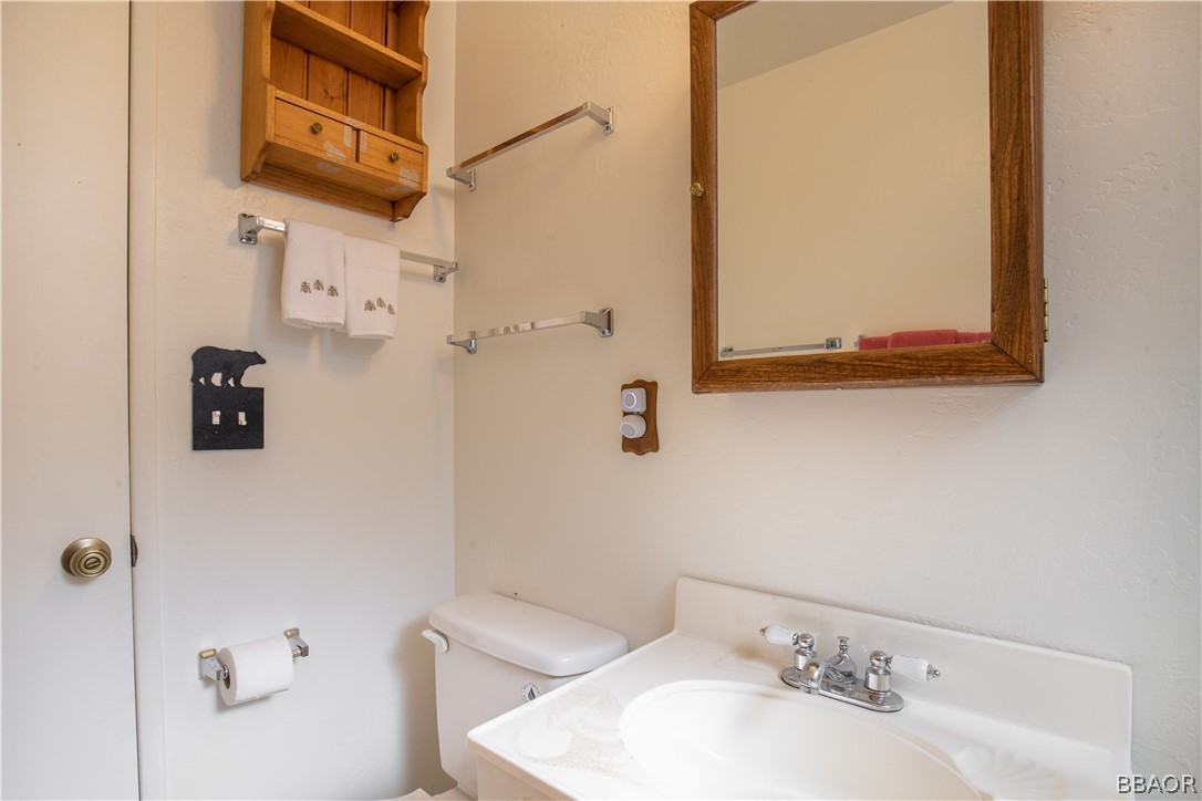753 Maple Lane Sugarloaf, CA 92386 - Photo 26 of 42 a bathroom with a sink and a mirror