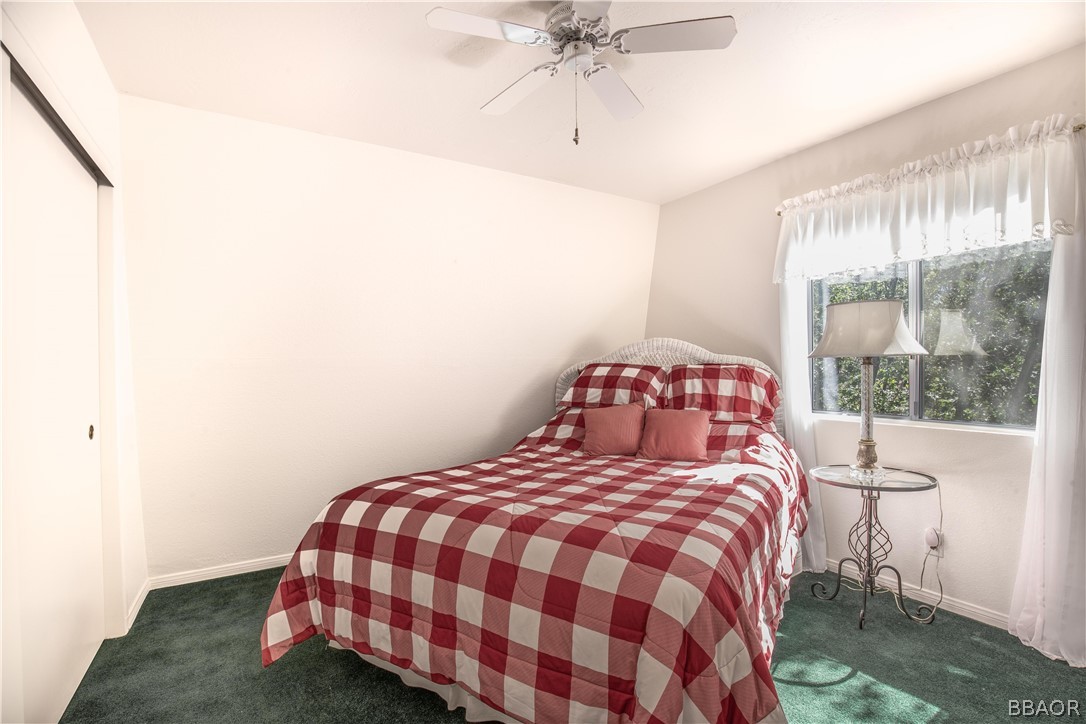 753 Maple Lane Sugarloaf, CA 92386 - Photo 27 of 42 a bedroom with a bed and a window
