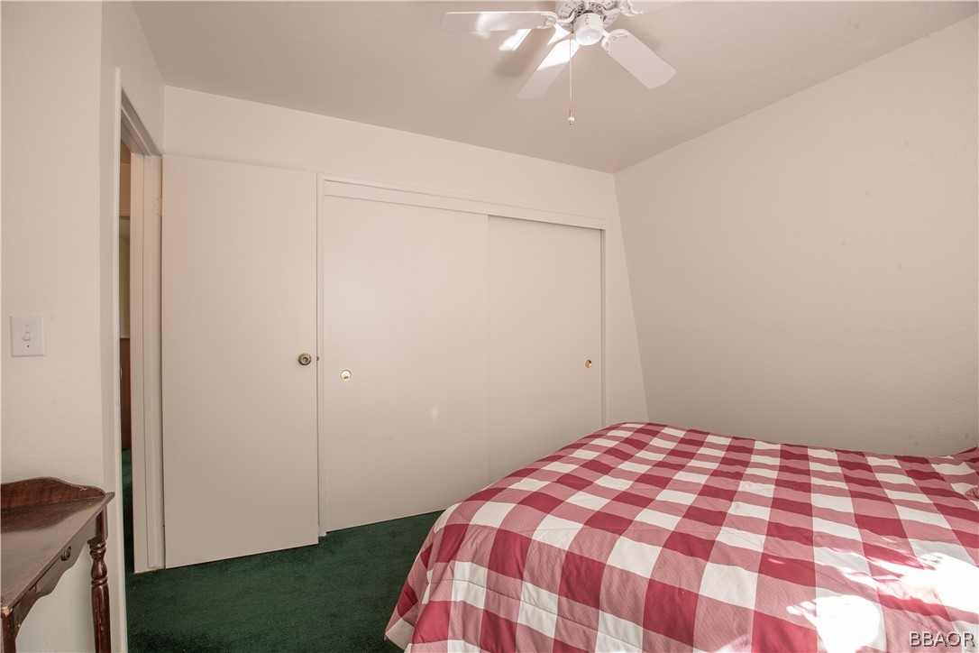 753 Maple Lane Sugarloaf, CA 92386 - Photo 29 of 42 a bedroom with a bed and a dresser