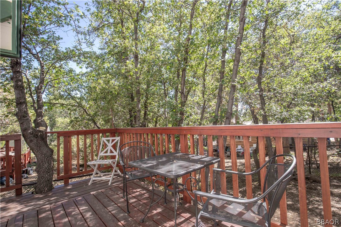 753 Maple Lane Sugarloaf, CA 92386 - Photo 35 of 42 a view of a patio with table and chairs and wooden floor