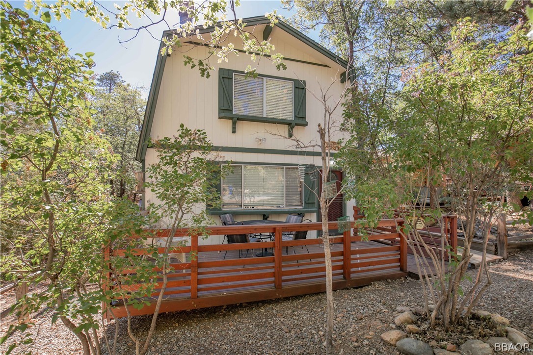 753 Maple Lane Sugarloaf, CA 92386 - Photo 6 of 42 a view of a wooden chairs and a table in the backyard
