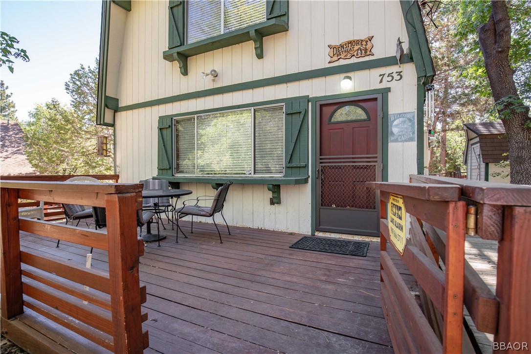 753 Maple Lane Sugarloaf, CA 92386 - Photo 9 of 42 a view of a patio with table and chairs with wooden floor and fence