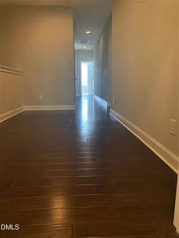 a view of a room with an empty space and a window