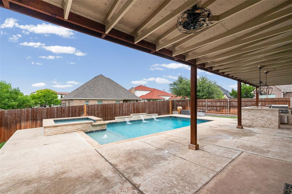 437 Prairie Run Aledo, TX 76008 - Photo 28 of 33 Expansive covered patio featuring a built-in outdoor kitchen, ceiling fan, and chandelier lighting