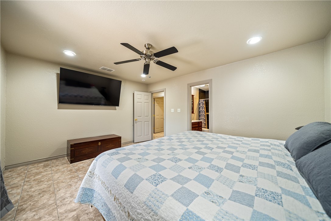 1777 County Road 170 Alice, TX 78332 - Photo 12 of 40 a bedroom with a bed and a flat screen tv