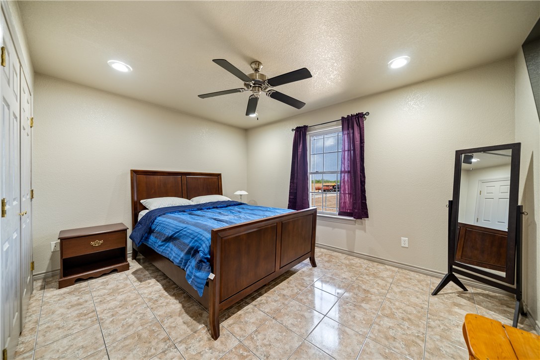 1777 County Road 170 Alice, TX 78332 - Photo 14 of 40 a bedroom with a bed and a chandelier