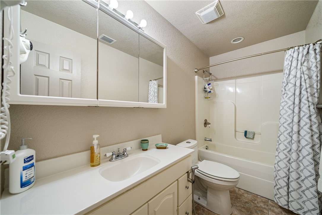 1777 County Road 170 Alice, TX 78332 - Photo 15 of 40 a bathroom with a sink a toilet and shower