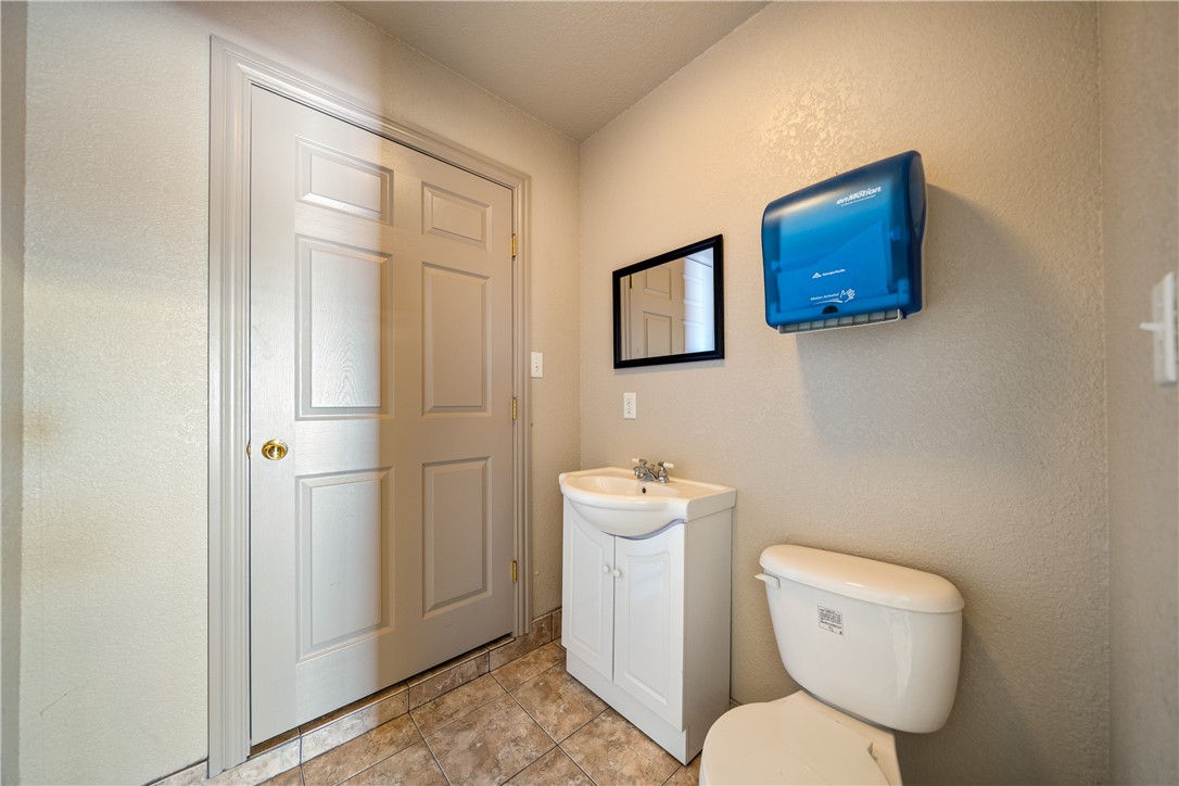 1777 County Road 170 Alice, TX 78332 - Photo 23 of 40 a white toilet sitting next to a bathroom sink