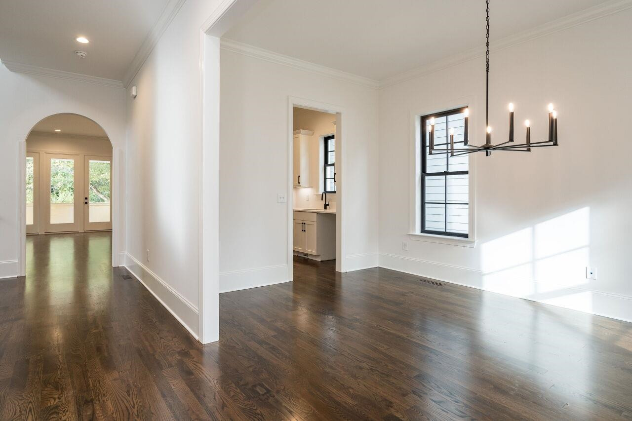 303 Shepherd Street Raleigh, NC 27607 - Photo 13 of 29 a view of empty room with wooden floor and window