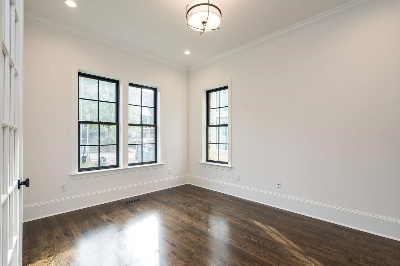 303 Shepherd Street Raleigh, NC 27607 - Photo 14 of 29 an empty room with wooden floor and windows