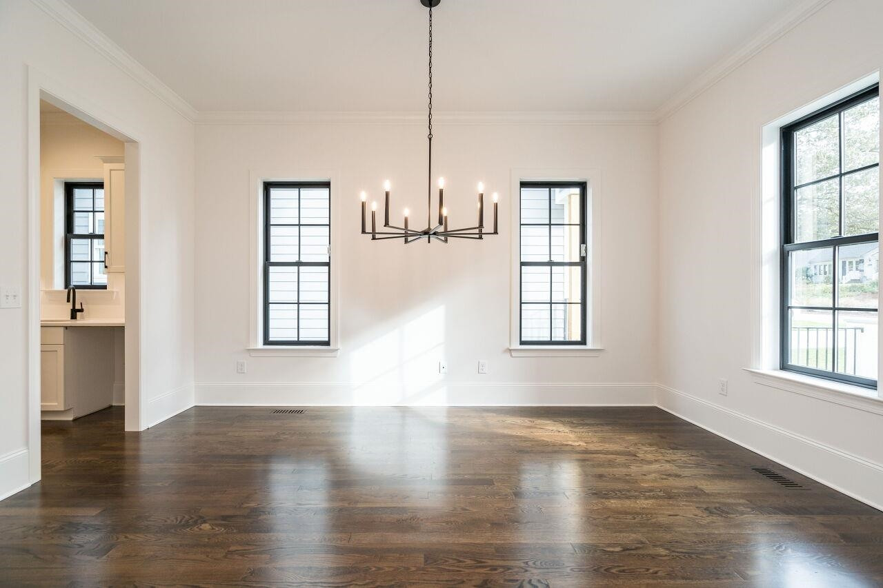 303 Shepherd Street Raleigh, NC 27607 - Photo 15 of 29 an empty room with wooden floor and windows