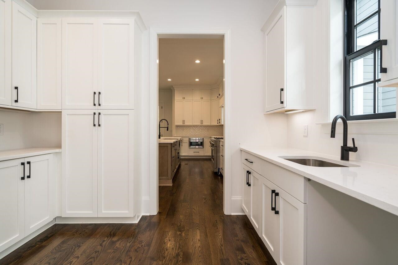 303 Shepherd Street Raleigh, NC 27607 - Photo 16 of 29 a kitchen with a sink and cabinets