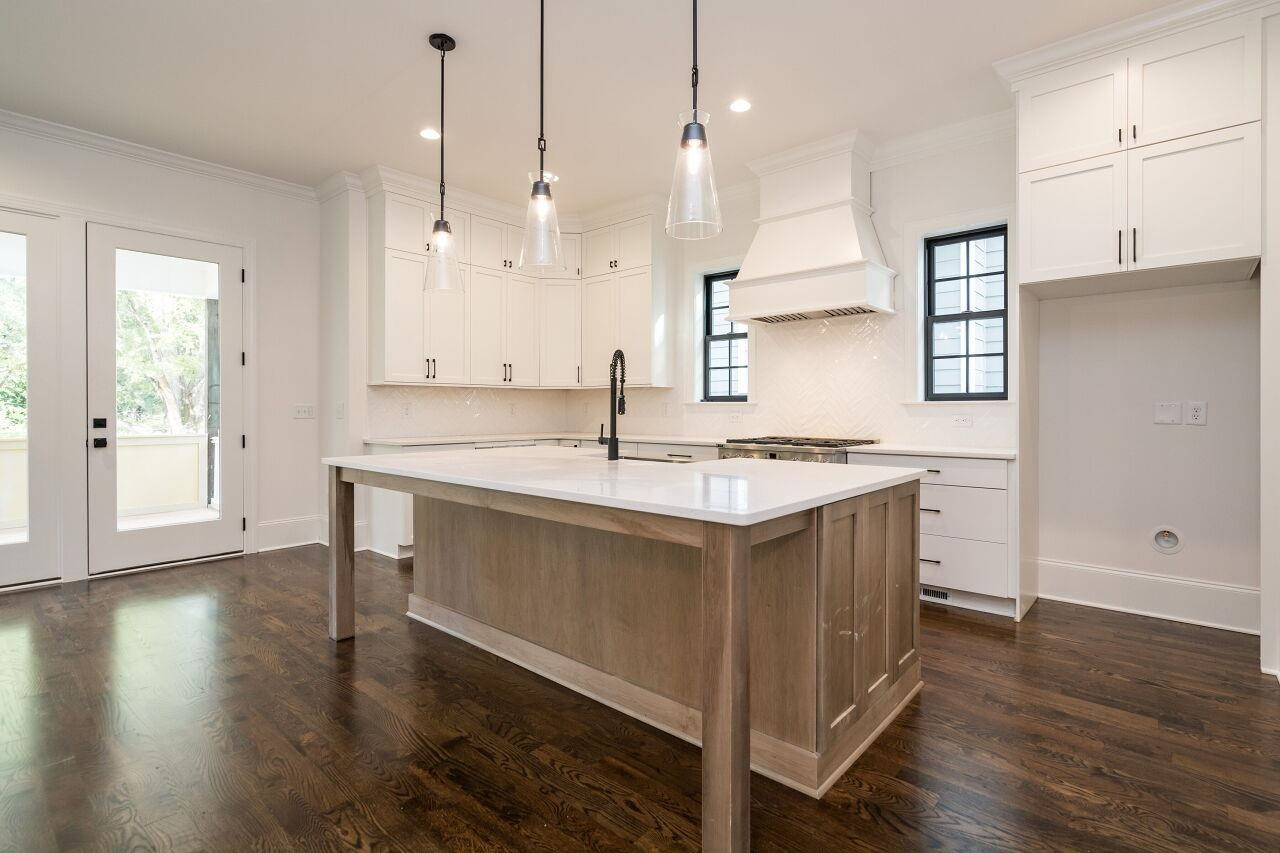 303 Shepherd Street Raleigh, NC 27607 - Photo 17 of 29 a kitchen with a sink stove and wooden floor
