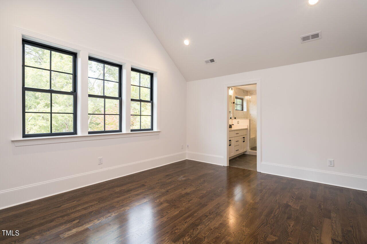 303 Shepherd Street Raleigh, NC 27607 - Photo 22 of 29 an empty room with wooden floor and windows