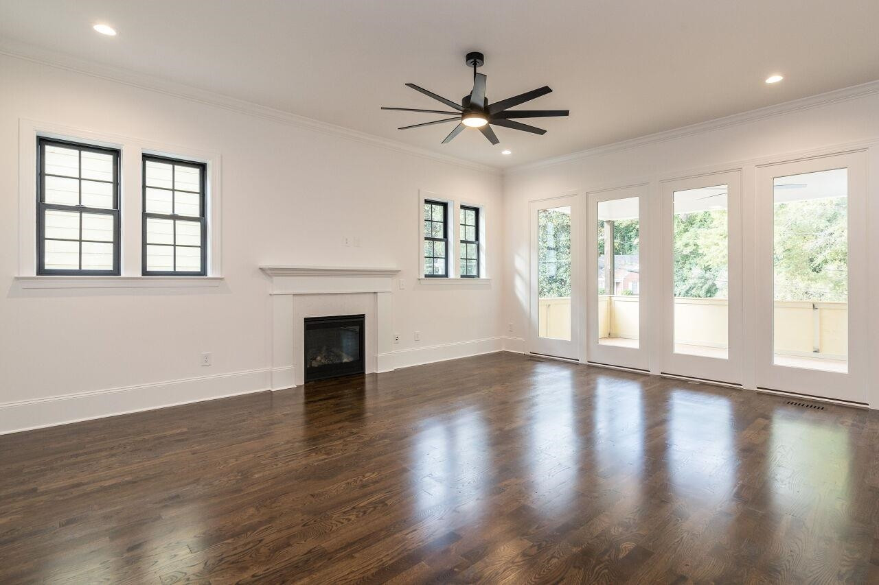 303 Shepherd Street Raleigh, NC 27607 - Photo 9 of 29 a view of an empty room with wooden floor and a window