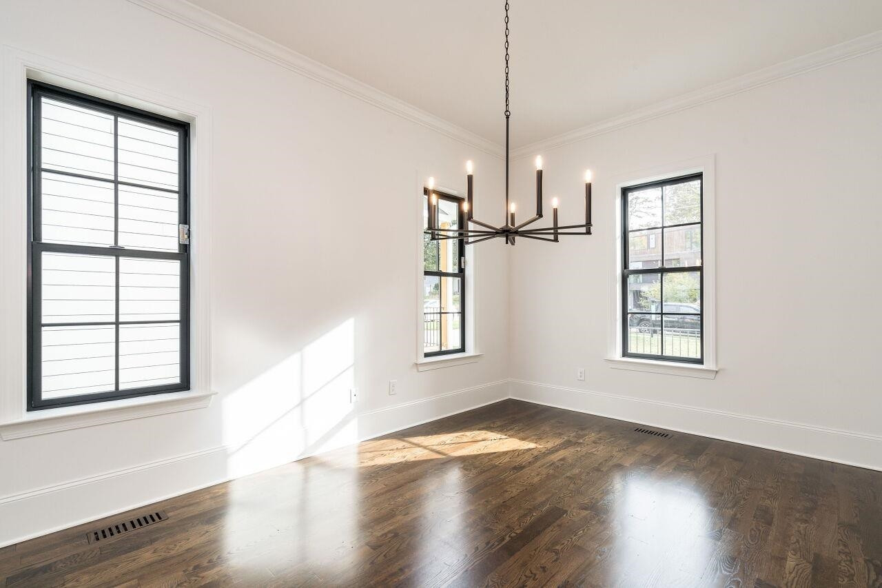 303 Shepherd Street Raleigh, NC 27607 - Photo 10 of 29 a view of empty room with wooden floor and fan