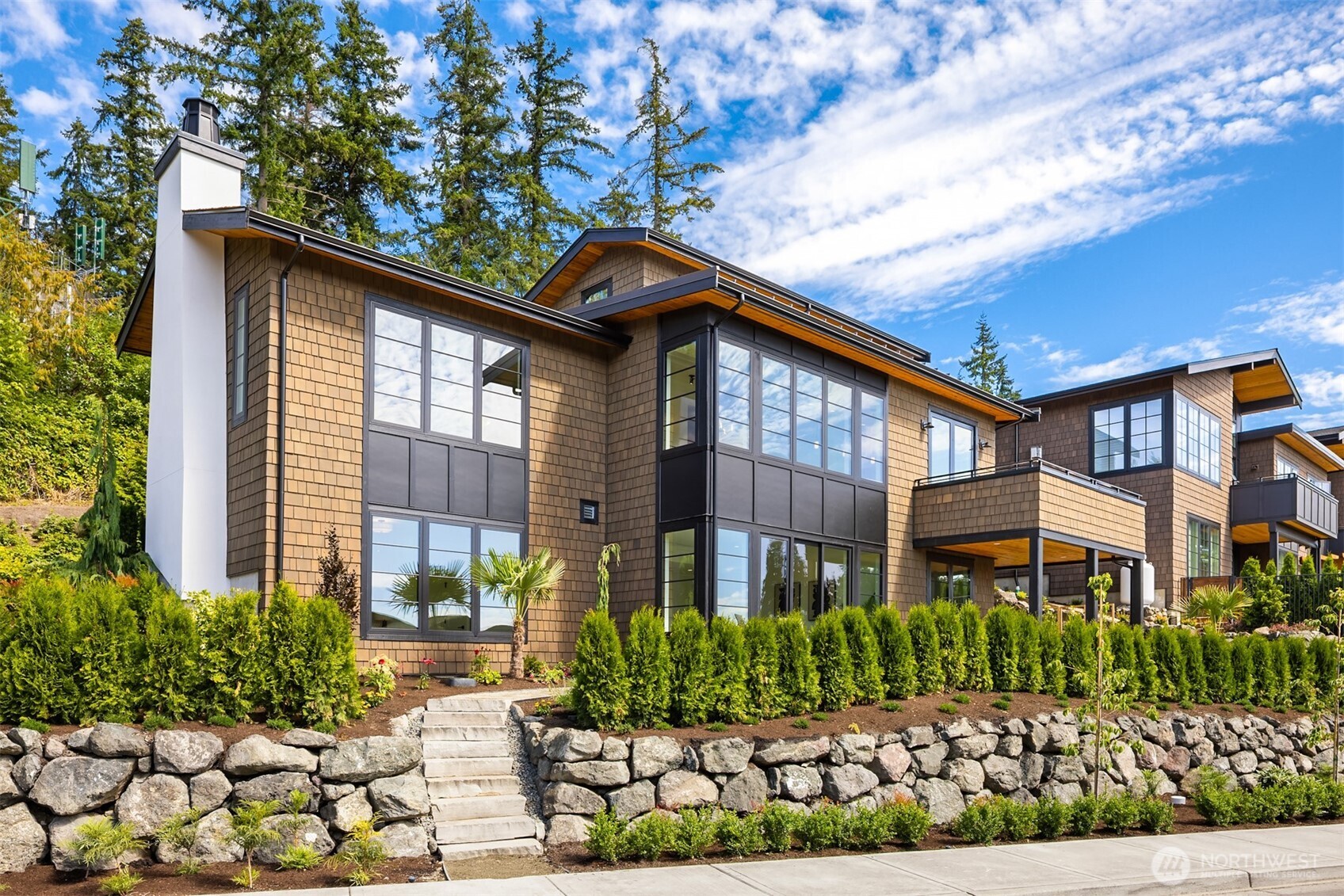 4869 Rosalind Road Northeast Bainbridge Island, WA 98110 - Photo 1 of 40 a front view of a house with a yard