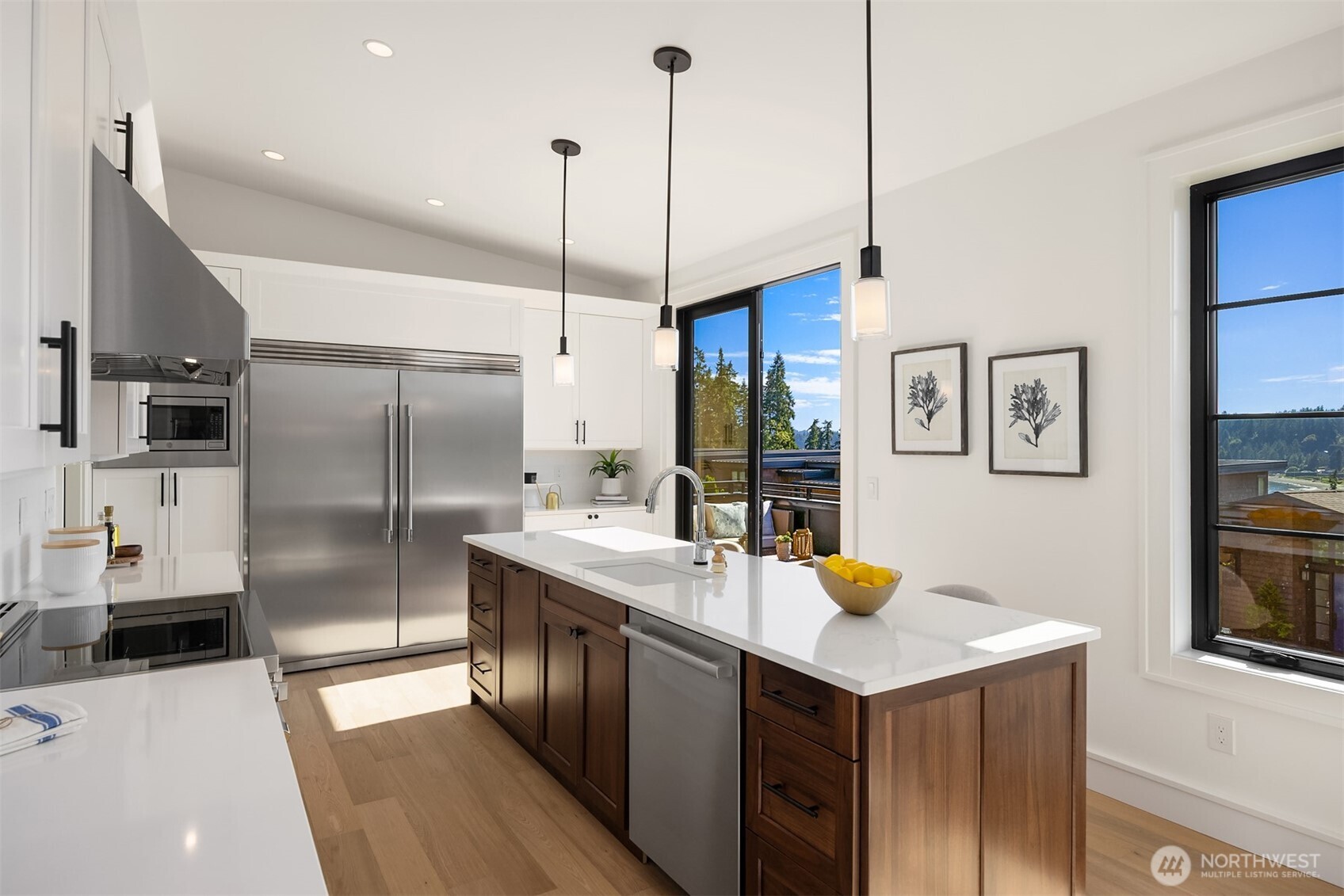 4869 Rosalind Road Northeast Bainbridge Island, WA 98110 - Photo 12 of 40 a kitchen with stainless steel appliances granite countertop a sink a refrigerator and a stove