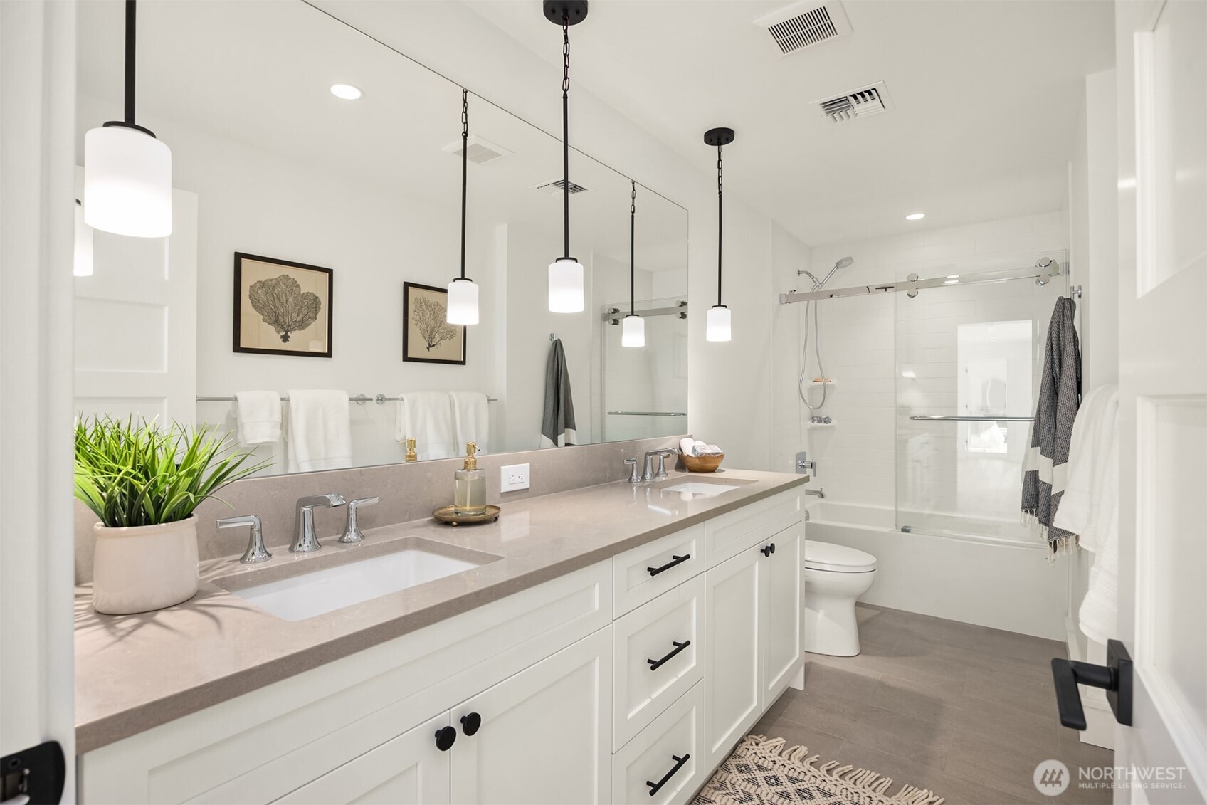 4869 Rosalind Road Northeast Bainbridge Island, WA 98110 - Photo 32 of 40 a bathroom with a double vanity sink mirror and toilet