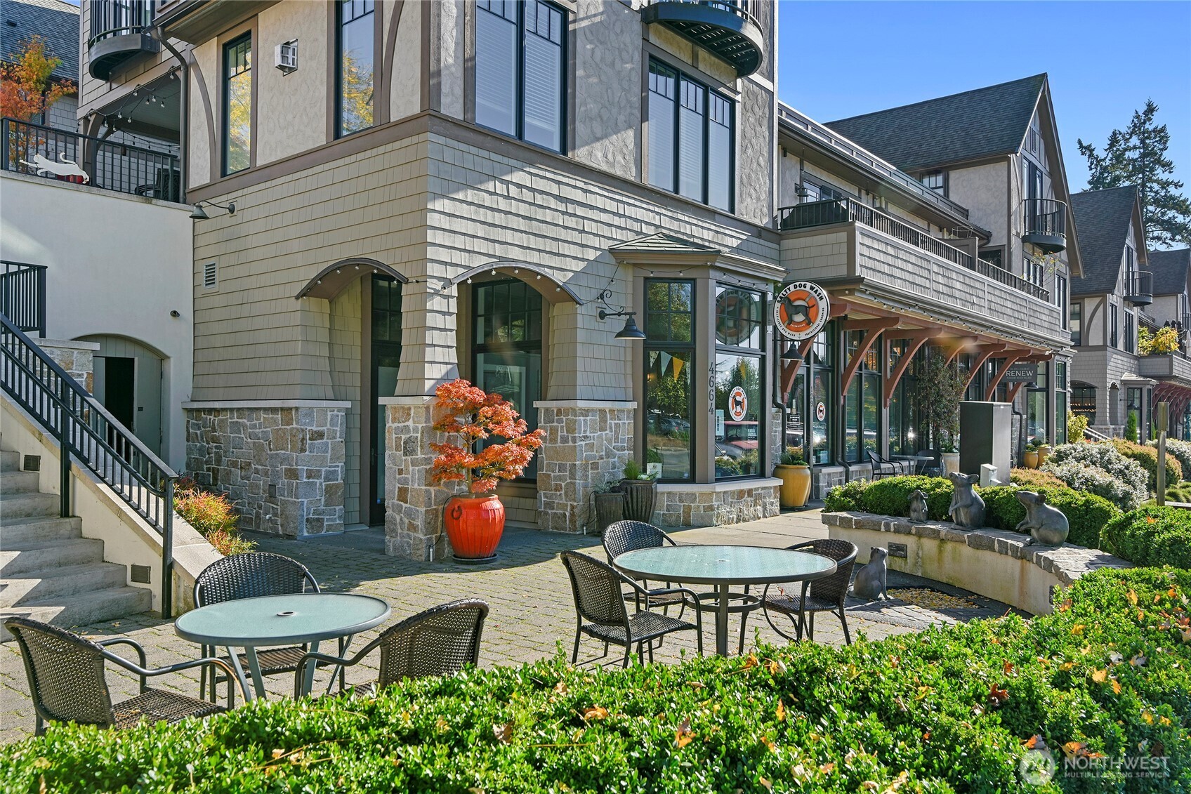 4869 Rosalind Road Northeast Bainbridge Island, WA 98110 - Photo 39 of 40 a view of a patio with a table and chairs and potted plants