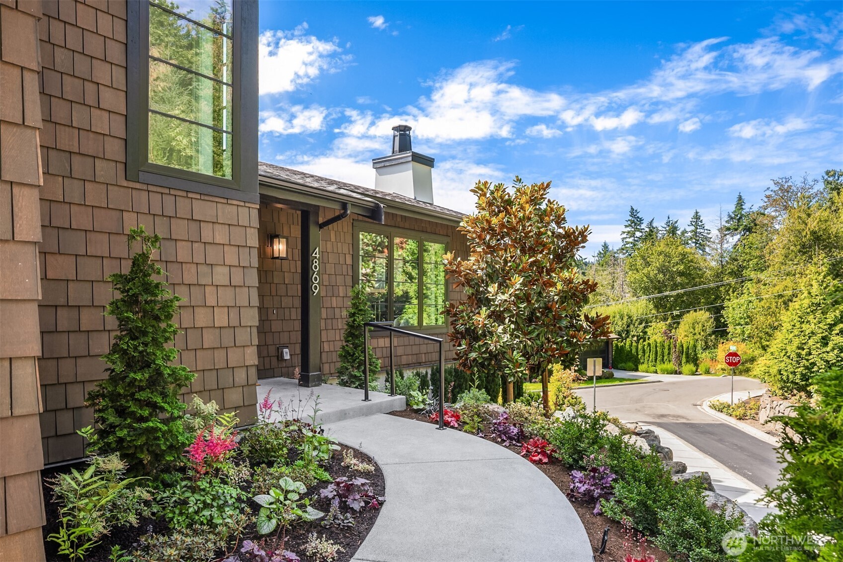 4869 Rosalind Road Northeast Bainbridge Island, WA 98110 - Photo 5 of 40 a front view of a house with a yard