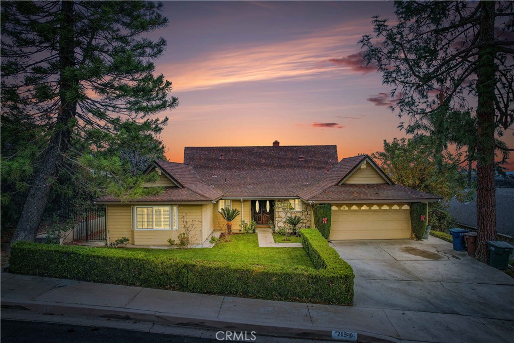 a front view of a house with a yard and a garage
