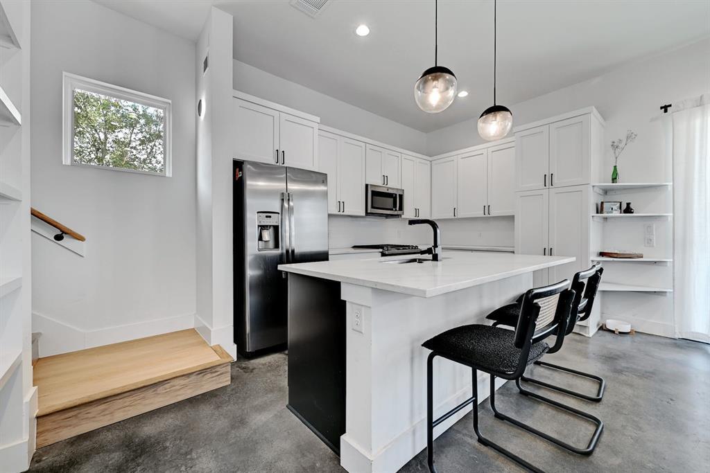 2812 East 4th Street, Unit 2 Austin, TX 78702 - Photo 10 of 26 Modern kitchen with white cabinetry and stainless steel appliances
