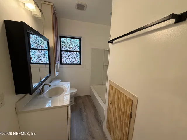 a bathroom with a sink a mirror and a toilet
