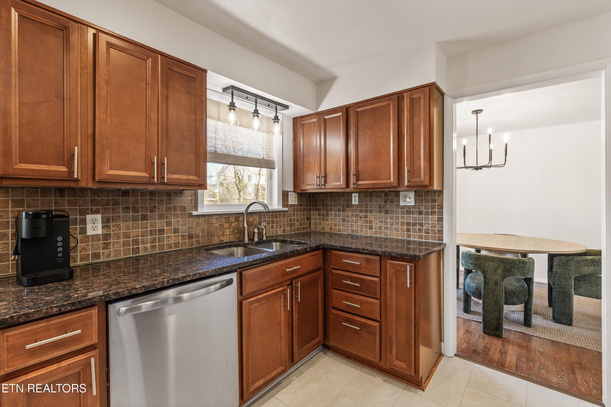 4912 Spring Creek Road Knoxville, TN 37920 - Photo 14 of 29 a kitchen with stainless steel appliances granite countertop wooden cabinets a sink and dishwasher