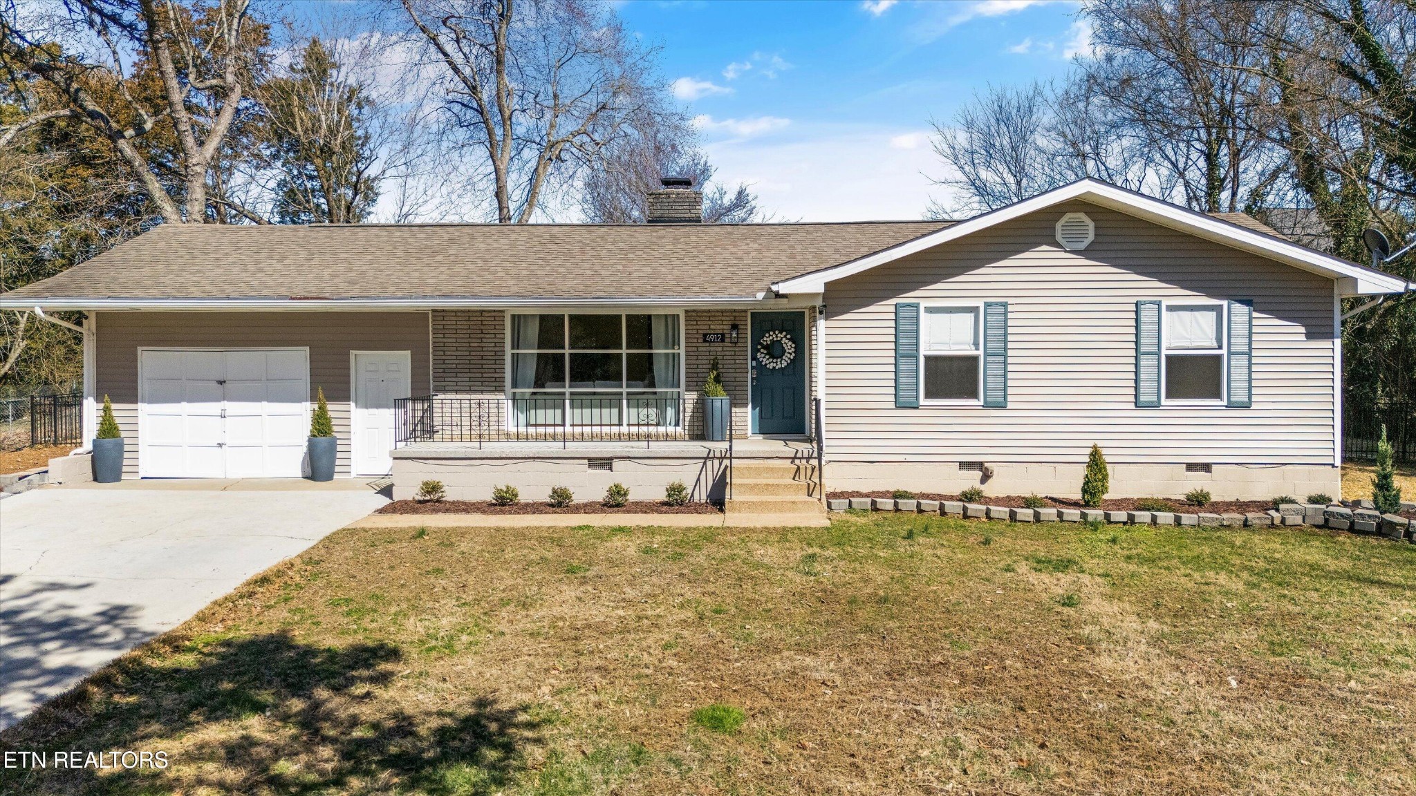 4912 Spring Creek Road Knoxville, TN 37920 - Photo 2 of 29 a house with trees in the background