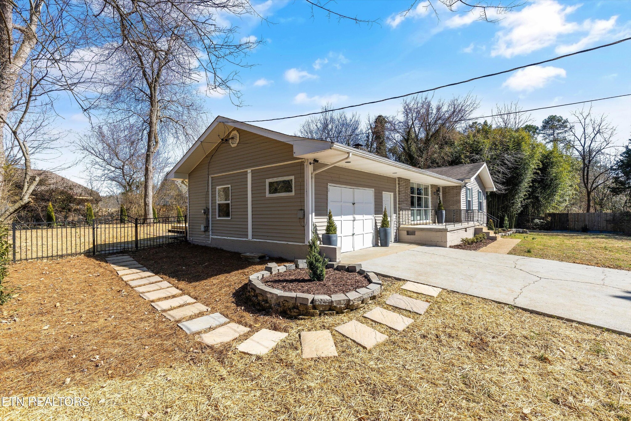 4912 Spring Creek Road Knoxville, TN 37920 - Photo 3 of 29 a front view of a house with a yard and garage