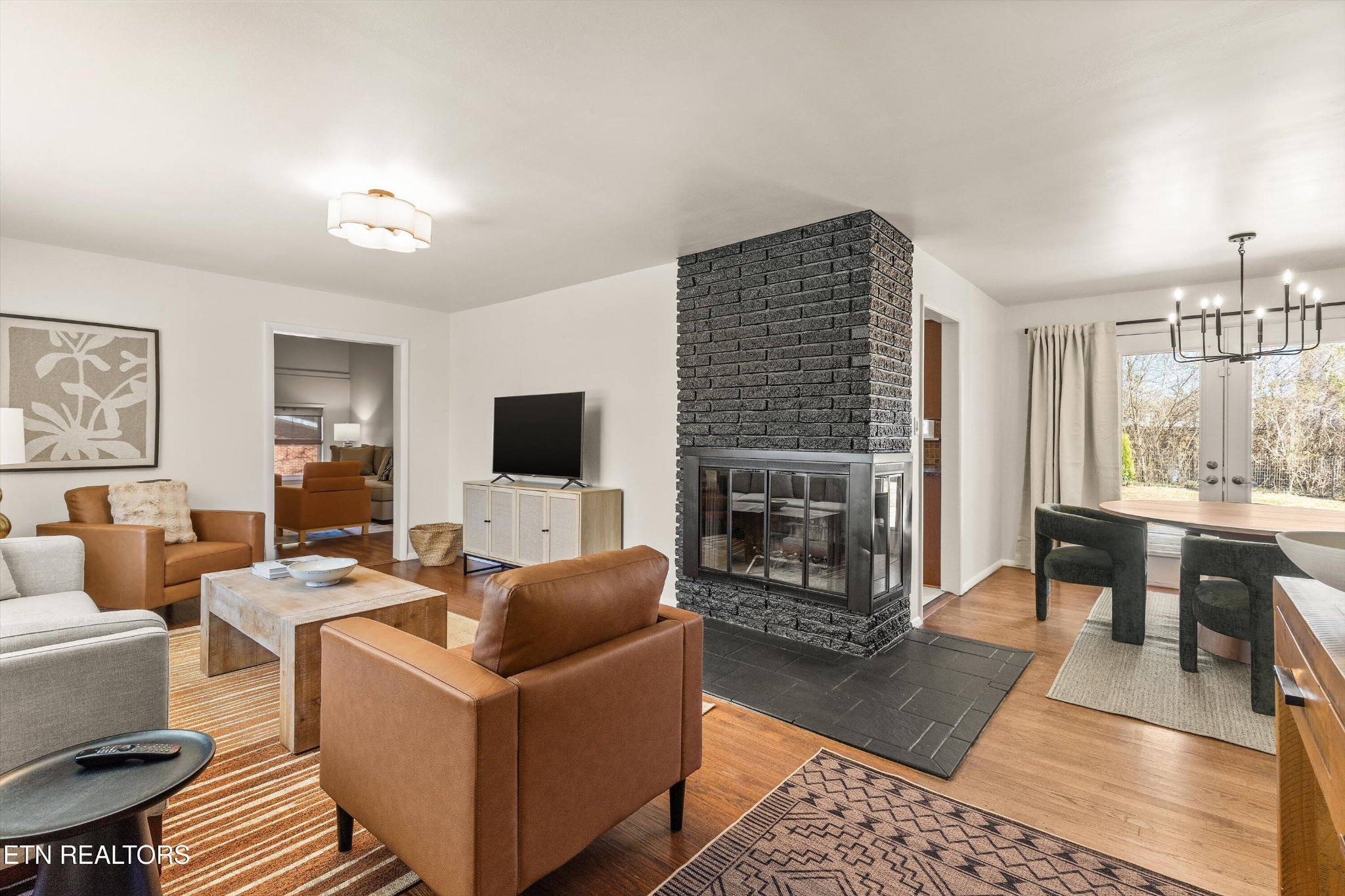 4912 Spring Creek Road Knoxville, TN 37920 - Photo 5 of 29 a living room with furniture a flat screen tv and a fireplace