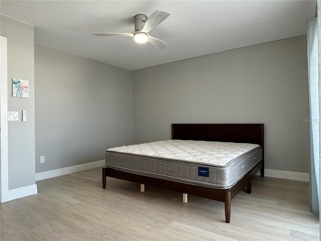 1244 Beachside Lane Indialantic, FL 32903 - Photo 15 of 25 a bedroom with a bed and a chandelier