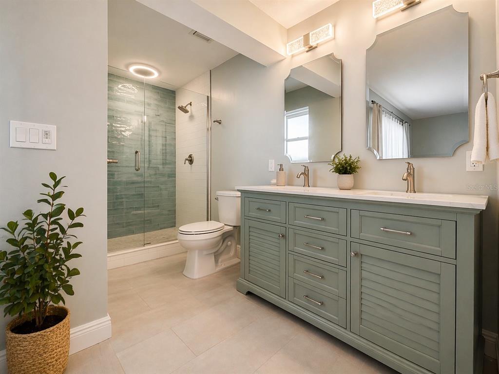 1244 Beachside Lane Indialantic, FL 32903 - Photo 16 of 25 a spacious bathroom with a double vanity sink mirror and toilet