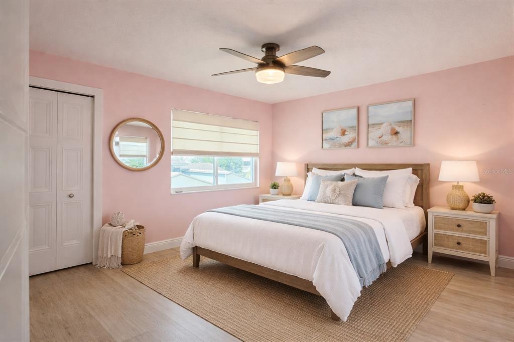 1244 Beachside Lane Indialantic, FL 32903 - Photo 18 of 25 a bedroom with a bed and a chandelier