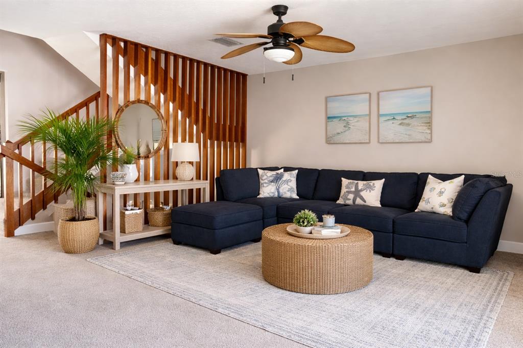 1244 Beachside Lane Indialantic, FL 32903 - Photo 4 of 25 a living room with furniture ceiling fan and a window