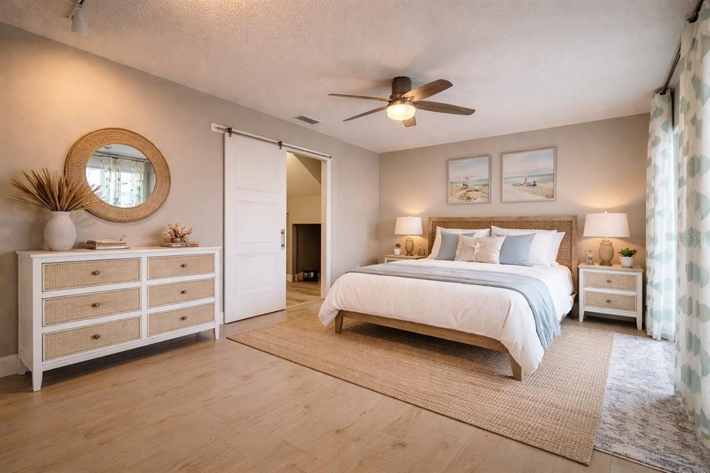1244 Beachside Lane Indialantic, FL 32903 - Photo 5 of 25 a bedroom with a bed and a chandelier
