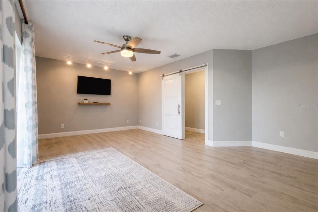 1244 Beachside Lane Indialantic, FL 32903 - Photo 6 of 25 a view of an empty room with a window and a kitchen