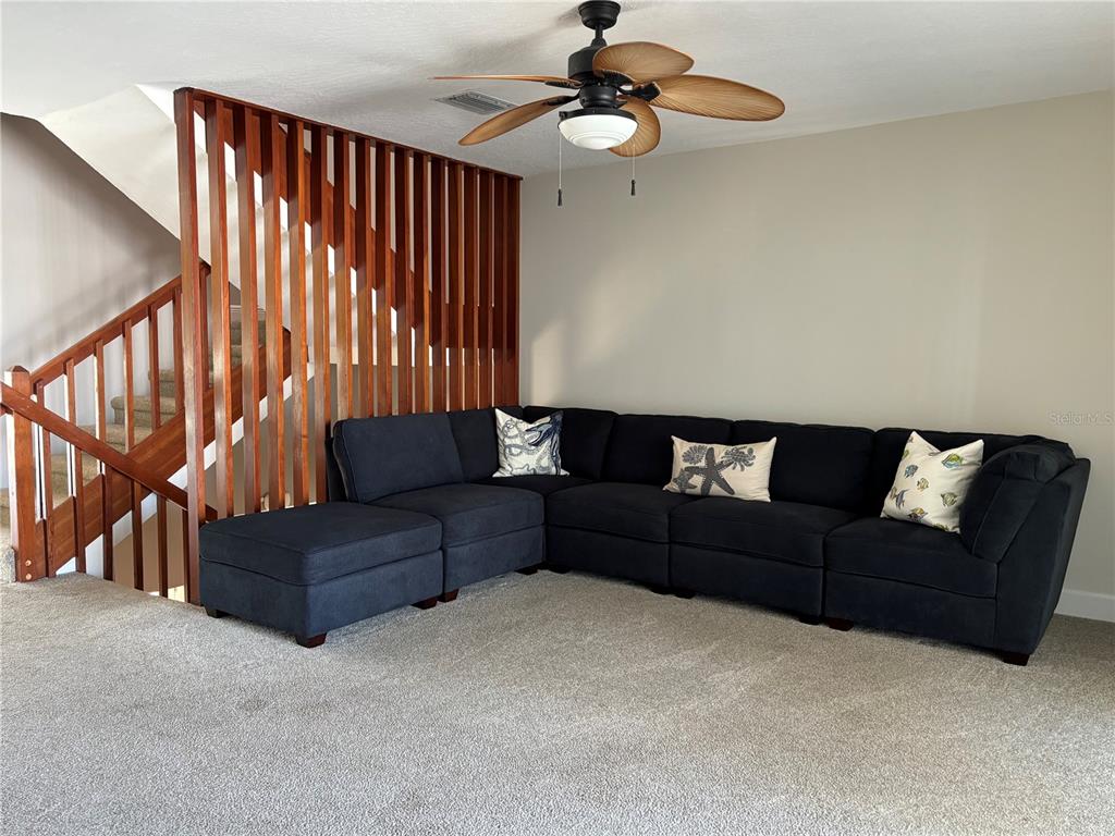 1244 Beachside Lane Indialantic, FL 32903 - Photo 8 of 25 a living room with furniture and a ceiling fan