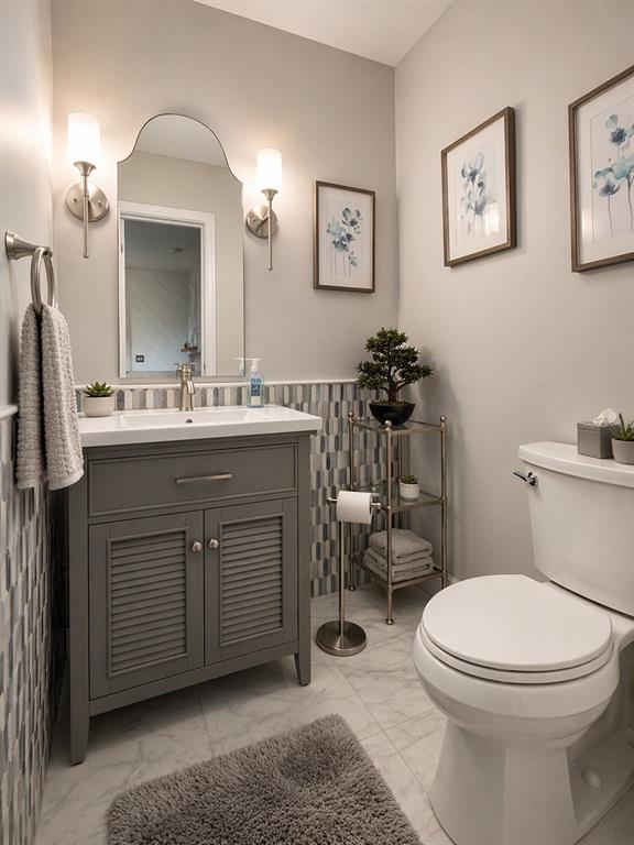1244 Beachside Lane Indialantic, FL 32903 - Photo 10 of 25 a bathroom with a toilet a sink and mirror